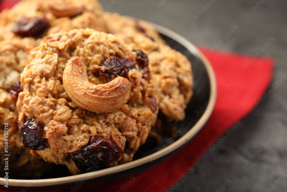Delicious oatmeal cookies with raisins and nuts on grey table, closeup Delicious oatmeal cookies with raisins and nuts on grey table, closeup