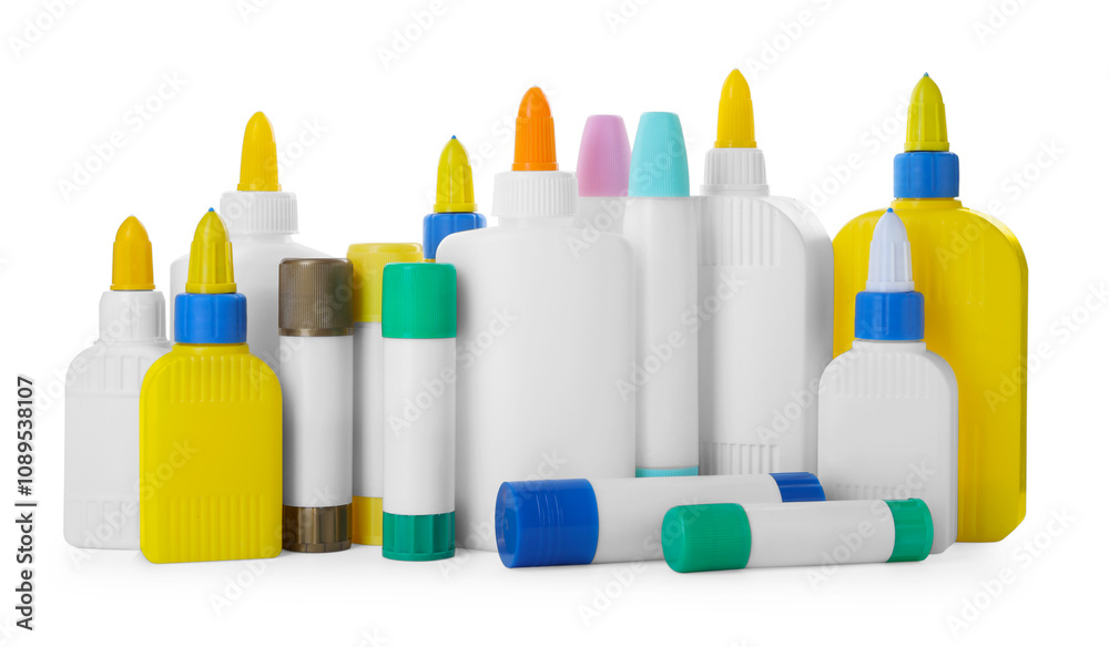 Fototapeta premium Bottles and sticks of glue on white background