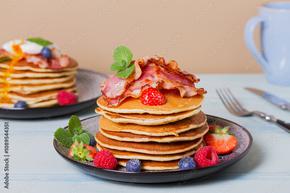 Stack of pancakes with savory topping and berries at breakfast Stack of pancakes with savory topping and berries at breakfast
