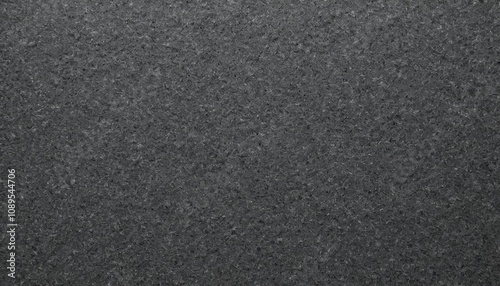 Dark textured sandpaper surface background with coarse finish photo