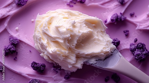 Creamy butter spread with rich texture on a vibrant purple background photo