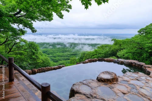 Akita's Nyuto Onsen hot springs surrounded by mist and dense, vibrant greenery photo