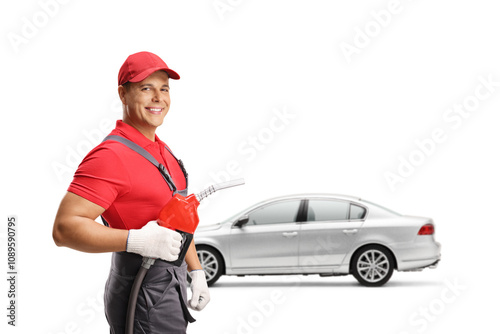 Gas station worker next to a car holding a petrol refueling gun and smiling photo