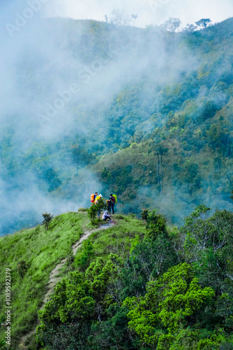 Exploratory hiking adventure mountain range nature photography misty environment elevated viewpoint outdoor experience