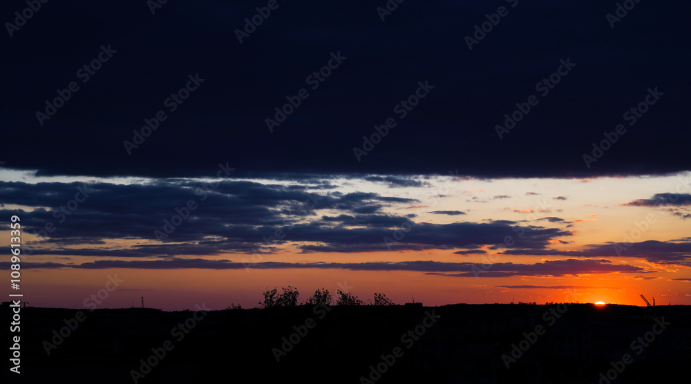Beautiful sunset over the city skyline, bright colors of the evening sky. Landscape photography. Evening and nature concept for design and print. Beautiful sunset over the city skyline, bright colors of the evening sky. Landscape photography. Evening and nature concept for design and print.