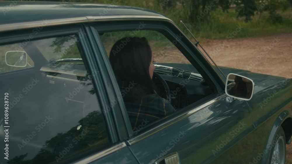 A woman abruptly gets out of a retro car when she sees smoke coming from under the hood A woman abruptly gets out of a retro car when she sees smoke coming from under the hood