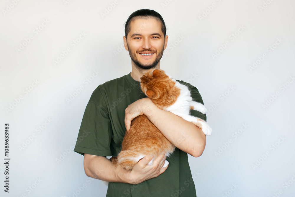 Portrait of young smiling man hugging fluffy orange cat with on white background. Portrait of young smiling man hugging fluffy orange cat with on white background.