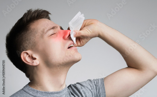 Young man with nosebleed or epistaxis, black and white photo, empty space
