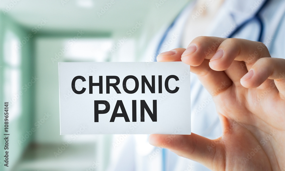 Doctor keeps a card with the name of the diagnosis - chronic pain. Selective focus. Medical concept.