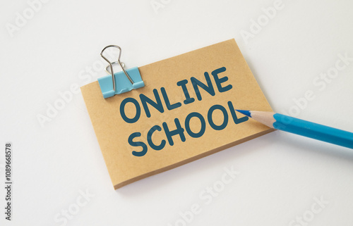 Blue pencil and brown paper tag with Online School text on white background. photo