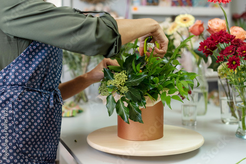 The hands of florist, making bouquets and flower arrangements. Woman collecting a bouquet of flowers. floristry