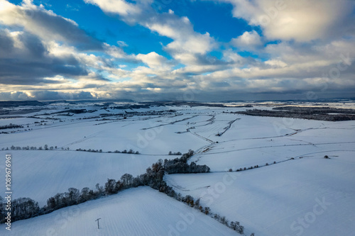 Obraz na płótnie Aerial view of a small German mountain village covered by heavy snow at sunset. Germany. w salonie