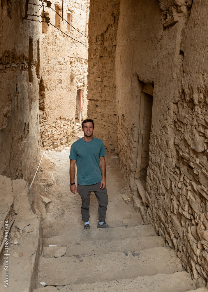 A man explores the ancient Birka Bint Al-Marzouq ruins in Oman, walking among the remnants of a historic settlement. A man explores the ancient Birka Bint Al-Marzouq ruins in Oman, walking among the remnants of a historic settlement.