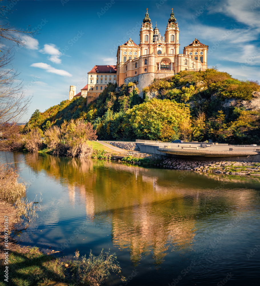 Amazing autumn view of Melk Abbey on the shore of Danube river. Wonderful morning cityscape of Melk town, Austria, Europe. Traveling concept background.