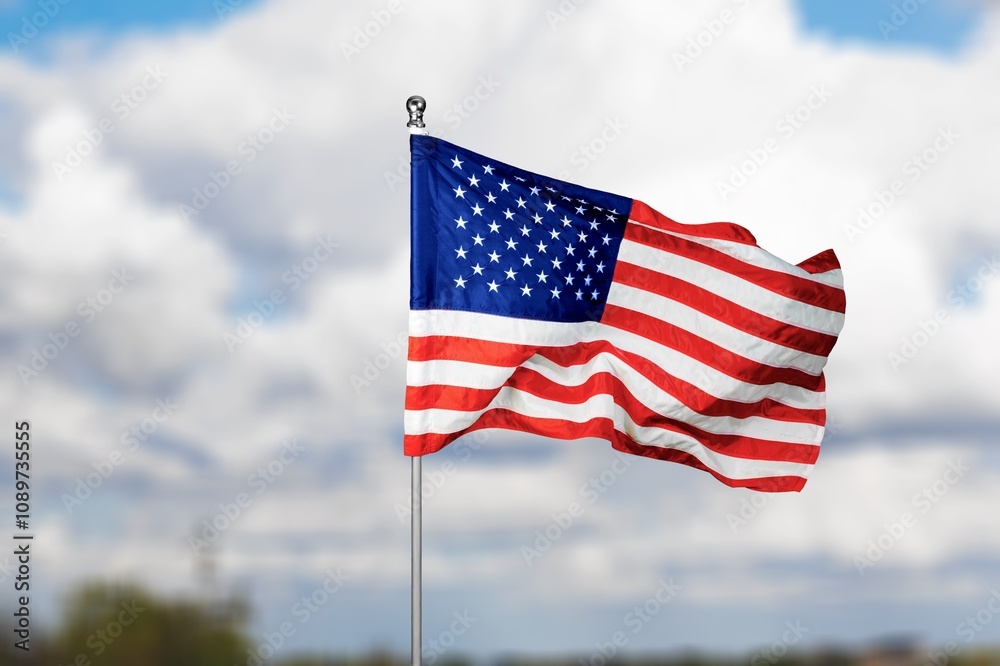 Fototapeta premium American Flag Blowing in Wind with Sky Background