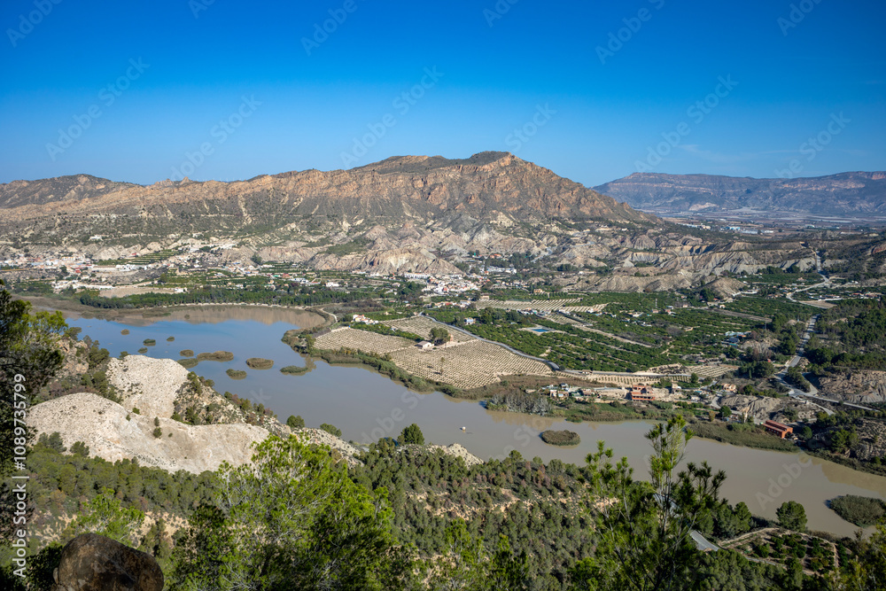 Obraz premium Panoramic view of the Ojós reservoir, in the Ricote Valley, Region of Murcia, Spain, with the town of Blanca in the background