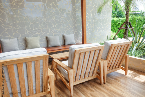 Wicker chair and wooden table in restaurant,Rattan chair in scandinavian interior of living room,Mediterranean minimal wall and green plant exterior architecturer,warm beige tones,copy space. photo