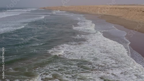 Scenic Moroccan beach featuring rolling waves and an endless sandy shore