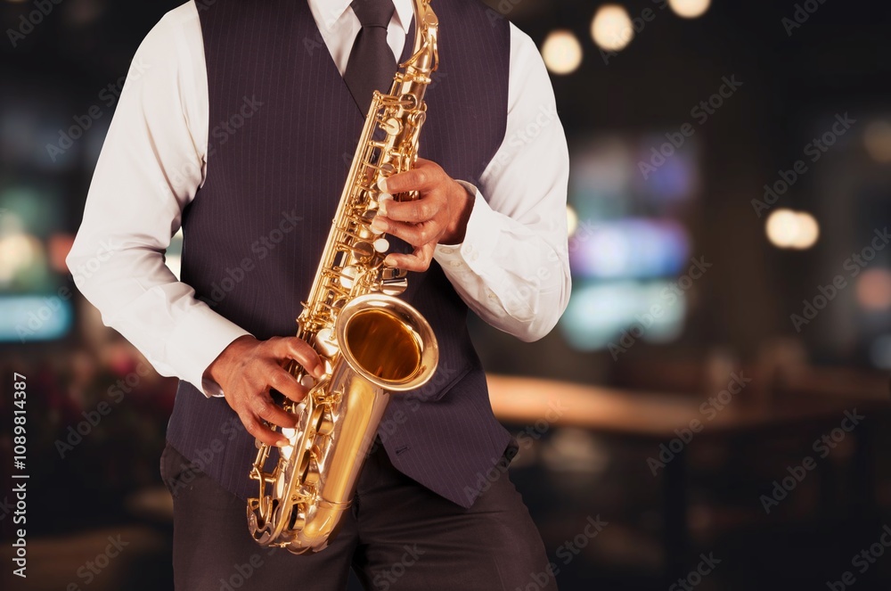 Naklejka premium Young jazz musician man playing saxophone
