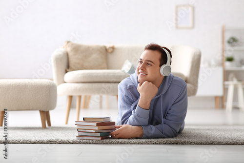 Young man listening audiobo...