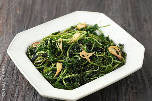 Jukut Goreng or Selada Air Goreng, Deep Fried Watercress with Salt and Friedn Onion. photo