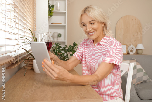 Mature woman with wine and ...