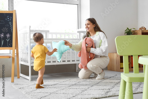 Happy mother and baby playi...