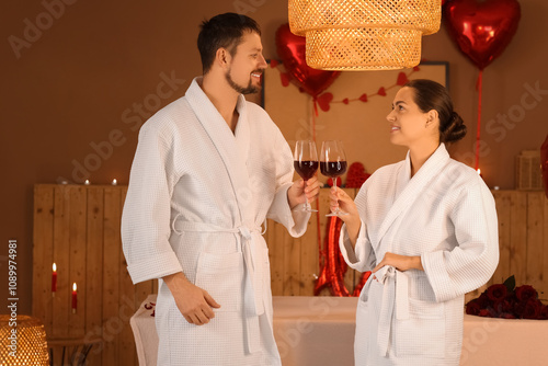 Young couple with wine in d...