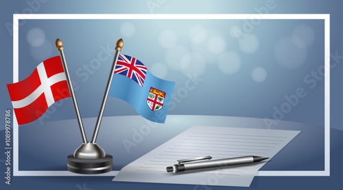 Denmark and Fiji National flags on small table with bokeh background, cooperative relationship