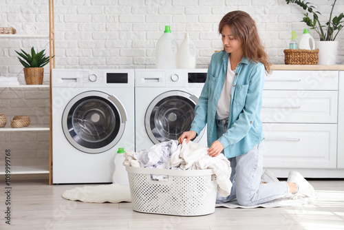 Young woman with laundry ba...