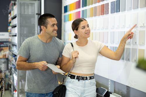 Married couple chooses ceramic tiles for kitchen or bath at a hardware store photo