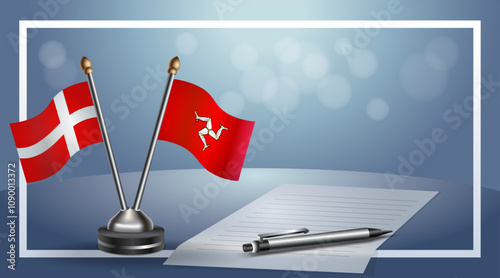 Denmark and Isle of Man National flags on small table with bokeh background, cooperative relationship