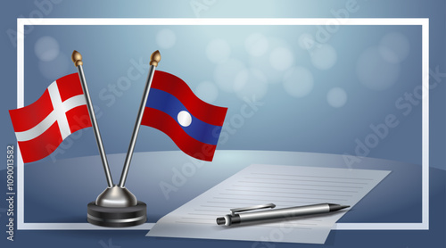 Denmark and Laos National flags on small table with bokeh background, cooperative relationship