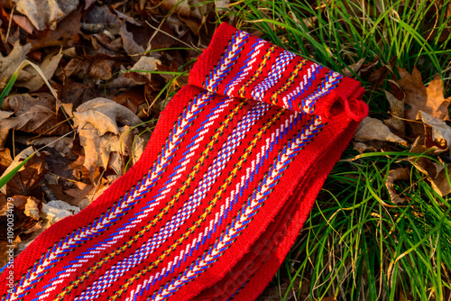 ceinture fléchée (traditional pattern) replica of the woven sash worn by voyageurs during the fur trade on ground room for text