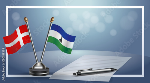 Denmark and Lesotho National flags on small table with bokeh background, cooperative relationship