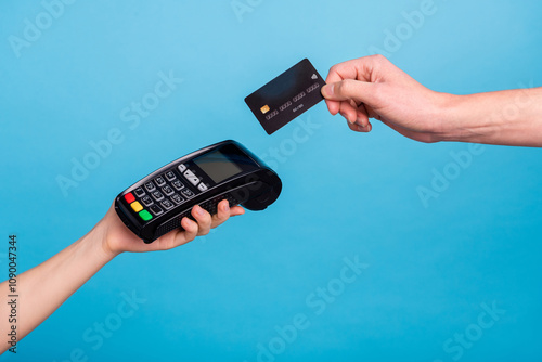 Cropped close up portrait of hands hols pos terminal credit card payment isolated on blue color background photo