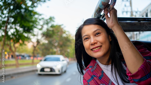 Happy Asian woman traveler enjoy and fun outdoor lifestyle travel in Thailand on summer holiday vacation. Attractive girl tourist travel in Chiang Mai city by three wheeled vehicles Tuk Tuk. 