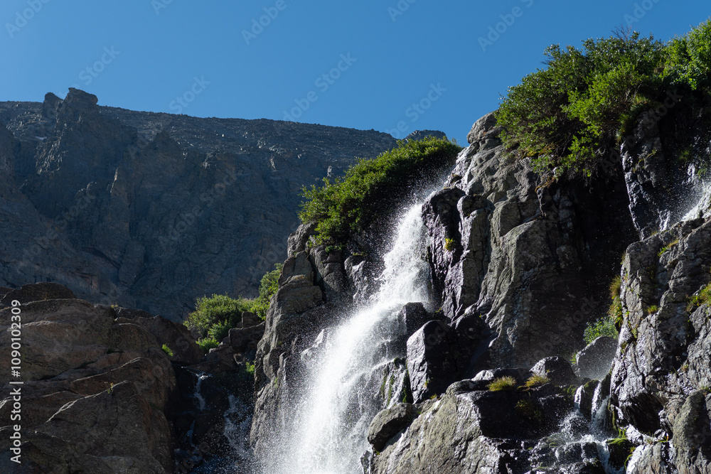 Fototapeta premium A stunning Timberline waterfall cascades down rocky cliffs in a Rocky mountain National Park