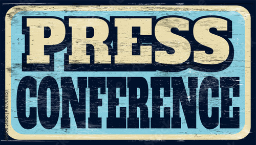 Aged and worn press conference sign on wood