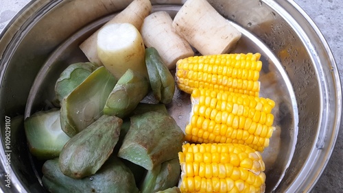 food that is steamed on a pan consisting of corn, radishes, and pumpkin. the benefits of steamed food are, low cholesterol, prevent cancer and diabetes. concept of healthy food, diabetes, cholesterol photo