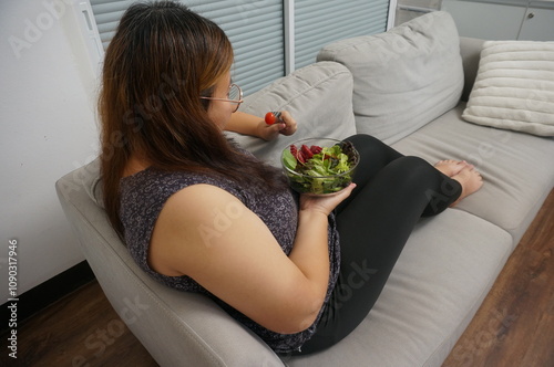Asian Overweight woman dieting Weight loss eating fresh fresh homemade salad healthy eating concept Obese Woman with weight diet lifestyle.