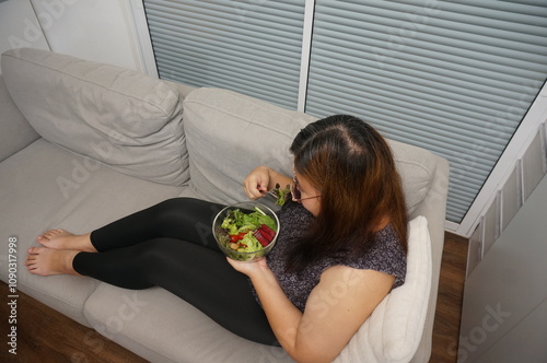 Asian Overweight woman dieting Weight loss eating fresh fresh homemade salad healthy eating concept Obese Woman with weight diet lifestyle.