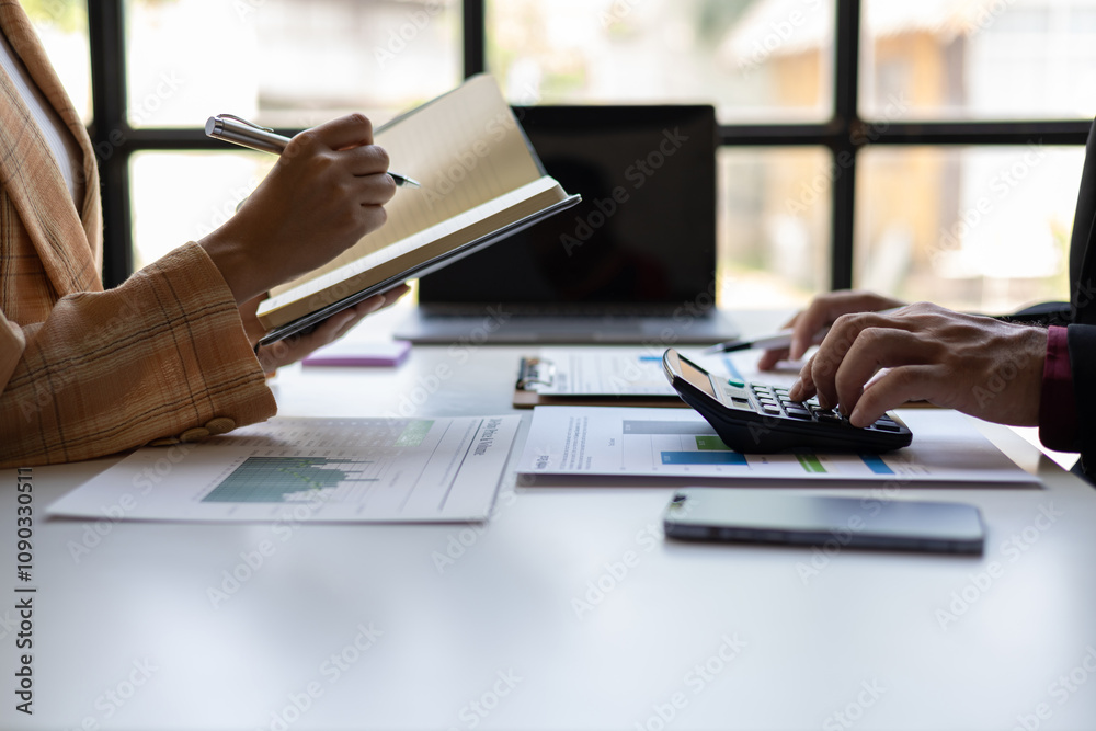 Fototapeta premium Meeting with a financial advisor and auditor are analyzing the financial figures in the business report. Investors are discussing cost analysis and reducing costs to increase profitability.