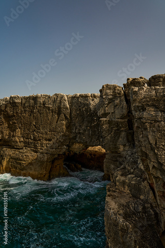 waves breaking at the rugged rocky coastline at cabo da roca. photo