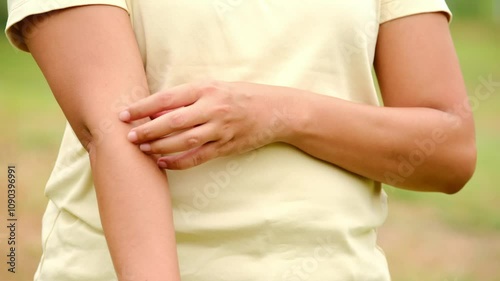 The woman's hands he uses his hands to scratch his back because of dermatitis and itch sensation.