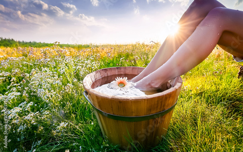 a foot bath in a wooden tub on the green meadow, Ki generated