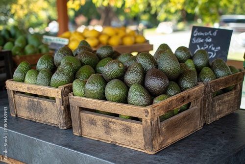 Freshly picked lamb hass avocados in wooden baskets at outdoor market display