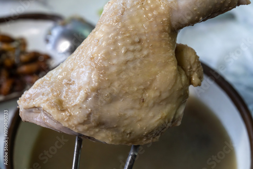 boiled chicken leg on the soup photo