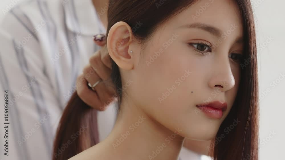 Young beautiful Asian woman having a hair styling by professional hairdresser in salon shop. Young beautiful Asian woman having a hair styling by professional hairdresser in salon shop.