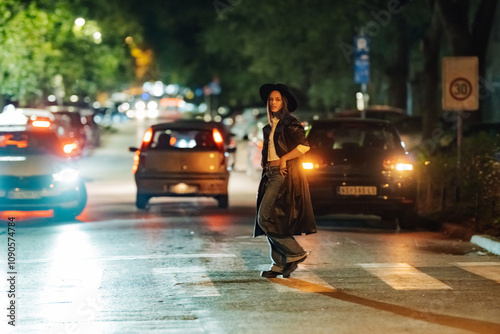 Wallpaper Mural Young stylish woman crossing the street at night with traffic in the background Torontodigital.ca